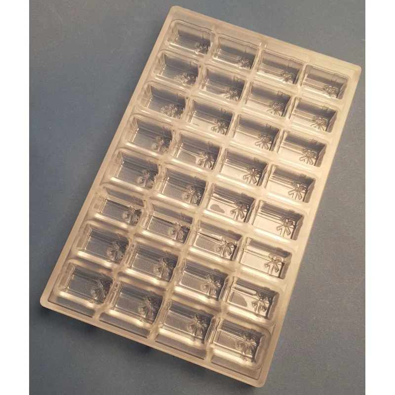 Thermoformed Polycarbonate Praline Chocolate Mold - Gift Parcel - 32 cavity - 38 mm x 22 mm x h 16 mm - 13.5gr Thermoformed Polycarbonate Praline Chocolate Mold - Gift Parcel - 32 cavity - 38 mm x 22 mm x h 16 mm - 13.5gr